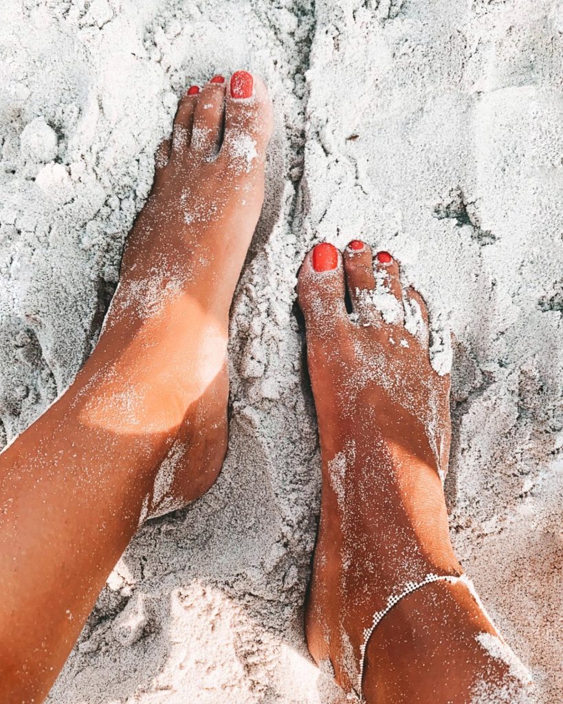 tanned red toe nails